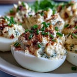 Million Dollar Deviled Eggs feature creamy yolk filling with mayo and cream cheese, nestled in tender egg white halves.