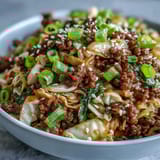 Wilted cabbage and crunchy carrots are tossed in a savory ginger-soy sauce for an easy low-carb weeknight meal.