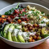 A close-up of a wholesome vegan Roasted Chickpea Power Bowl with avocado, spinach, and smoky paprika chickpeas.