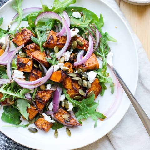 A vibrant Roasted Sweet Potato Salad featuring honey-lime dressing and toasted pumpkin seeds.